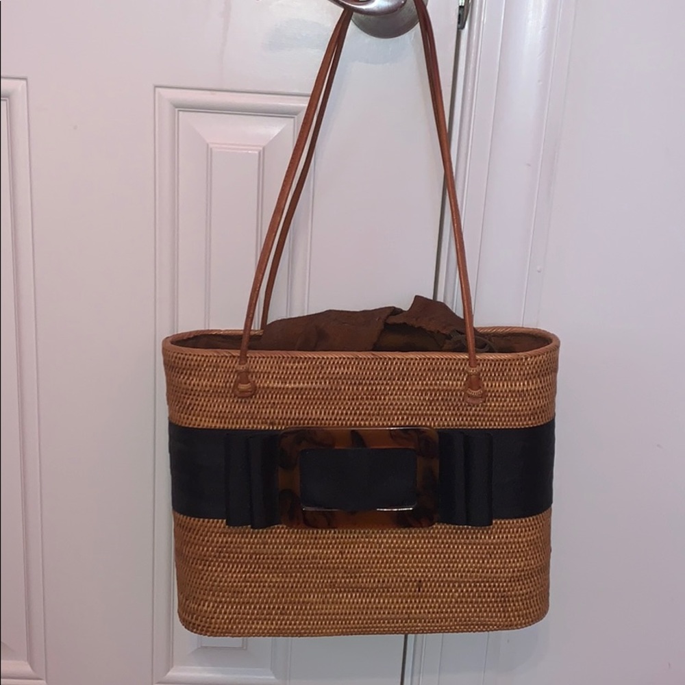 Black straw tote bag with tortoise shell pendent
